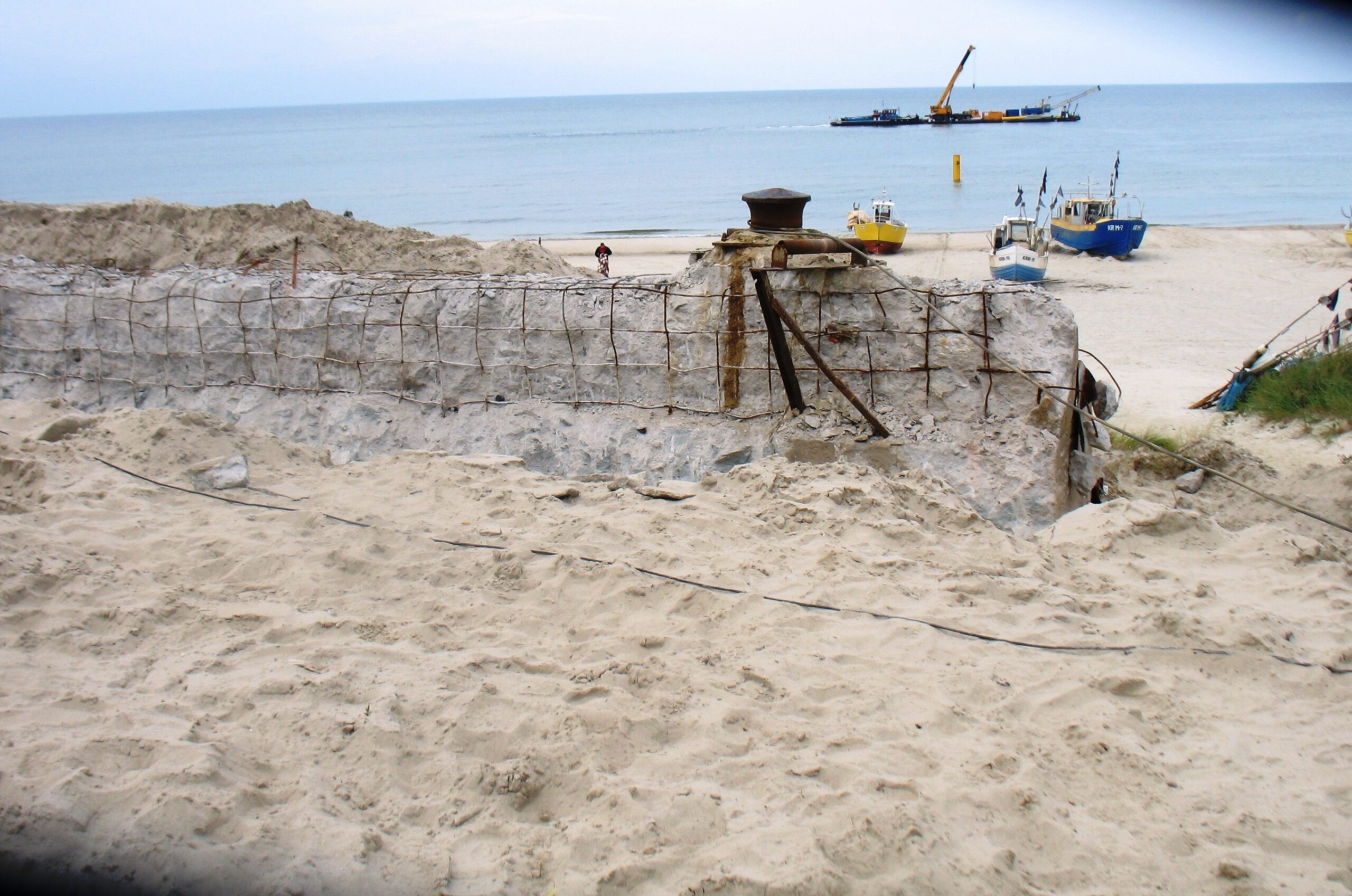 zbrojony mur na plaży z widokiem na dalbe